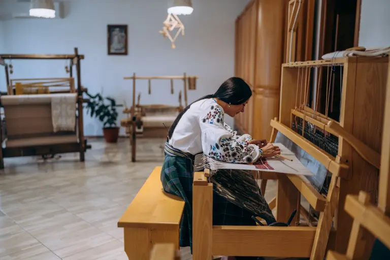 Дівчина за ткацьким верстатом в етнопарку Ладомирія. Фото: Софія Соляр.